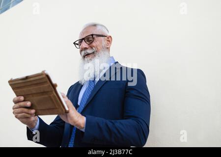 Business senior hipster man using tablet computer outdoor - Focus on face Stock Photo