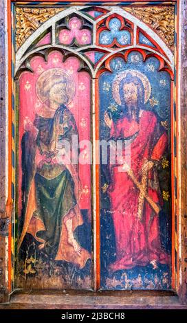 St Peter and St Andrew (L-R) on the rood screen of about 1400 in St James' church at Castle Acre, Norfolk. Stock Photo