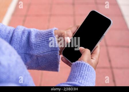 Unrecognizable  african american woman using modern smartphone With Black Screen Stock Photo