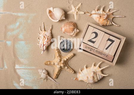 Calendar from September 27 with a compass, sand and seashells ...