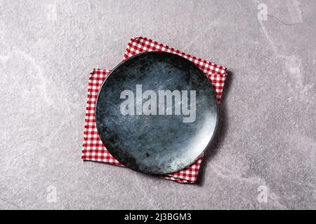 Black and blue empty plate on gray background Stock Photo