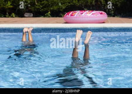 Childs feet on a swimming pool