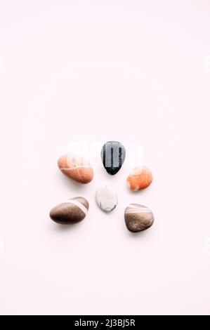 flat lay of sea pebbles on light background. abstract wallpaper Stock Photo