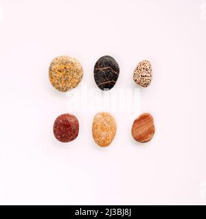 Flat lay of sea pebbles on light background. Top view, sea concept Stock Photo