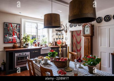 Farmhouse kitchen with 1950s French beaded curtain in 17th century Suffolk home, UK Stock Photo