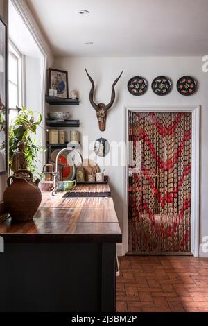 1950s French beaded curtain and oyster plates in 17th century Suffolk home, UK Stock Photo