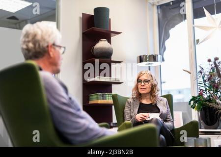 Senior man and woman talking over coffee Stock Photo