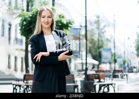 portrait of a young businesswoman against the background of a city street . Stock Photo