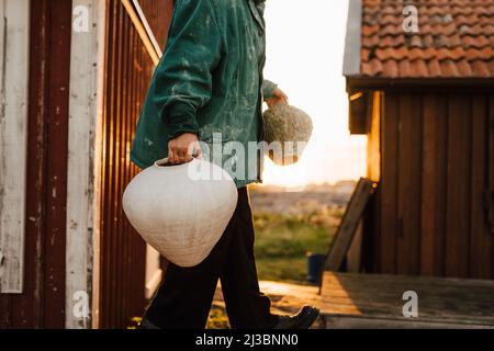 Young woman carrying handmade vases Stock Photo