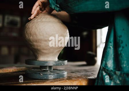 Female potter making vase in workshop Stock Photo