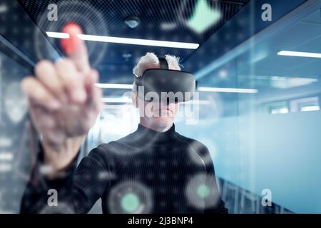 Senior man in virtual reality headset using advanced technology Stock Photo