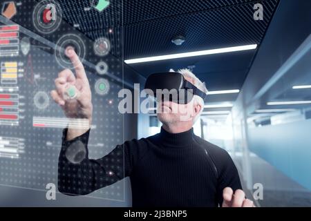 Senior man in virtual reality headset using advanced technology Stock Photo