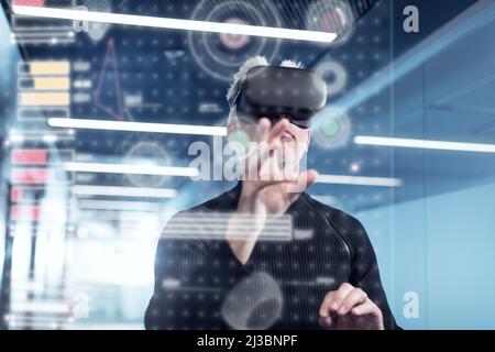 Senior man in virtual reality headset using advanced technology Stock Photo