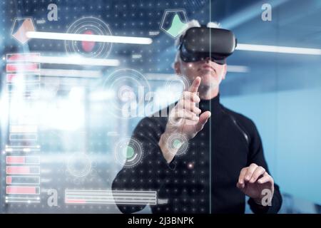 Senior man in virtual reality headset using advanced technology Stock Photo