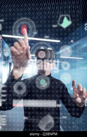 Senior man in virtual reality headset using advanced technology Stock Photo