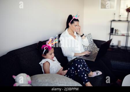 Mother and daughter on sofa Stock Photo