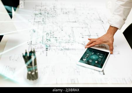 Architect using digital tablet on whiteprint Stock Photo