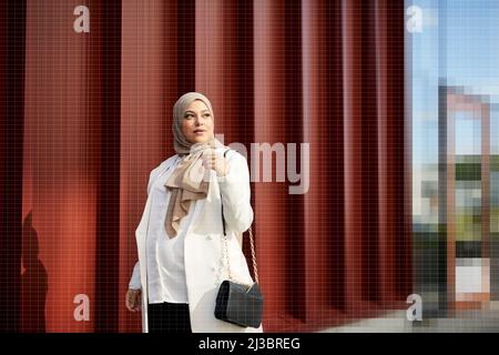 Pregnant young woman in headscarf Stock Photo