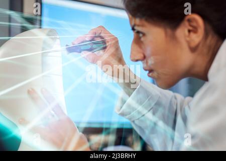Young female engineer building robot Stock Photo