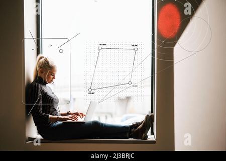 Young female engineer working on laptop Stock Photo