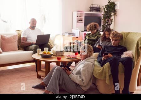 Family with children using electronic devices at home Stock Photo