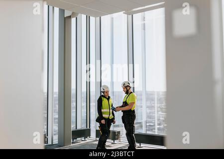 Workers talking at construction site Stock Photo