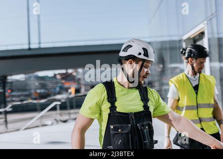 Man talking at construction site Stock Photo