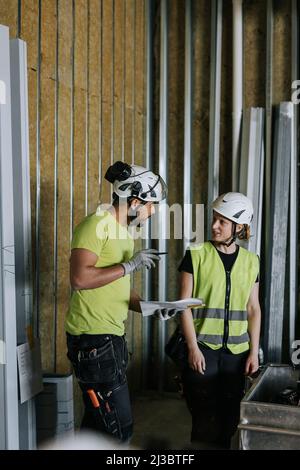 People talking at construction site Stock Photo