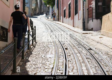 Funicular rails in a steep street in the old part of Lisbon, Portugal. Stock Photo