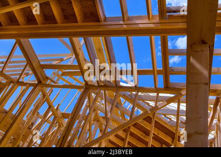 Installation of wooden beams at construction the assembled ceiling and wall on house Stock Photo