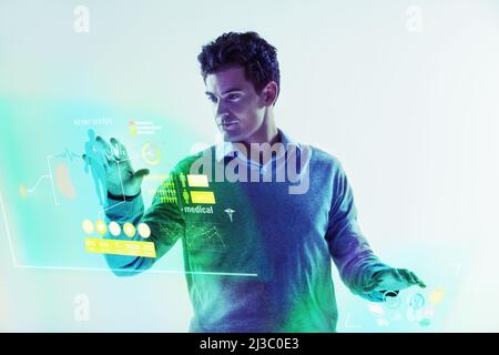 Photo manipulated shot of a young man using a theoretical digital interface.All screen content is designed by us and not copyrighted by others, and Stock Photo