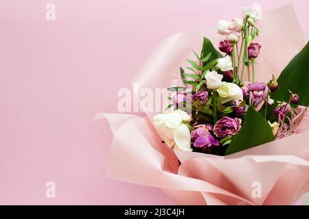 bouquet of dying flowers on pink background Stock Photo