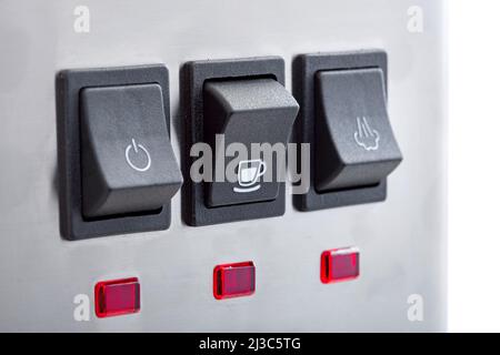 Black plastic buttons with turn on making coffee with a white cup icon of panel with buttons for professional espresso coffee machine of gray stainles Stock Photo
