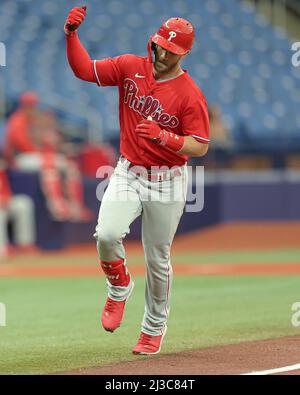 Philadelphia Phillies - Photo of Bryce Harper catching a ball on the field  at Citizens Bank Park. He is wearing a long sleeve red Phillies shirt, red  and white pinstripe baseball pants