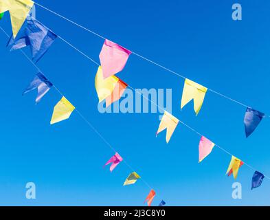 Background of flags for junina party, famous party of Brazil that happens in the months of June and July. Brazilian Culture Concept Image. Stock Photo