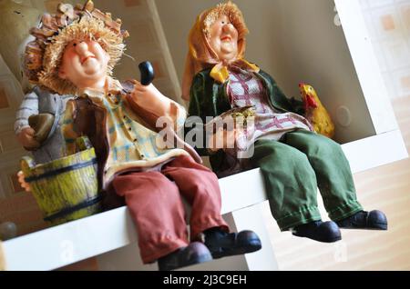 Souvenirs toys and vintage resin grandfather old man doll and retro grandmother senior woman on shelf for show in local gifts shop for thai people tra Stock Photo