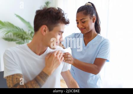 black rehabilitation woman physiotherapy at physio clinic with customer Stock Photo