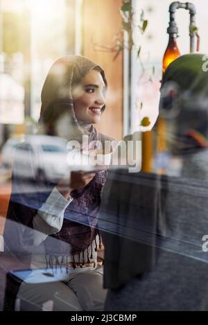 Two of lifes greatest perks, coffee and friends. Shot of two women having coffee in a cafe. Stock Photo