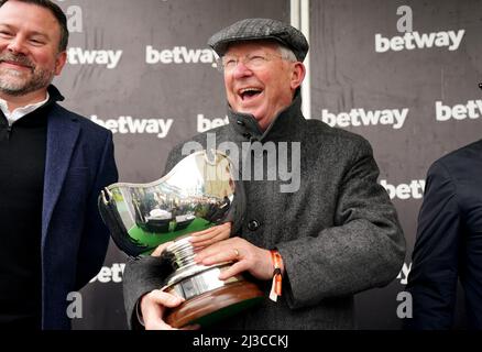 Co-owner Sir Alex Ferguson celebrates with the Betway Bowl trophy after Clan Des Obeaux wins the Betway Bowl Chase at Aintree Racecourse, Liverpool. Picture date: Thursday April 7, 2022. Stock Photo