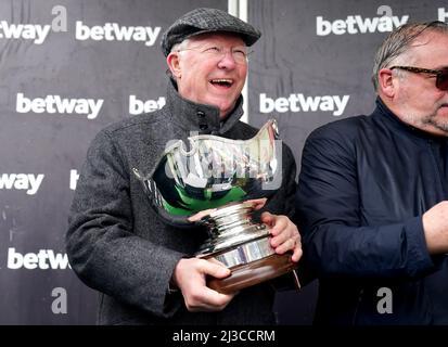 Co-owner Sir Alex Ferguson celebrates with the Betway Bowl trophy after Clan Des Obeaux wins the Betway Bowl Chase at Aintree Racecourse, Liverpool. Picture date: Thursday April 7, 2022. Stock Photo