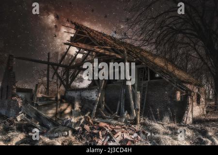 an abandoned farm on a starry night Stock Photo