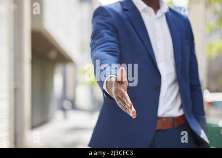 Let me introduce you to your next move. Cropped shot of an unrecognizable businessman holding his hand out for a handshake in a modern office. Stock Photo
