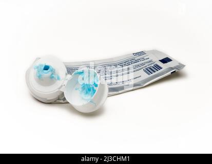 A used tube of toothpaste with the usual mess and clog at the tip Stock Photo