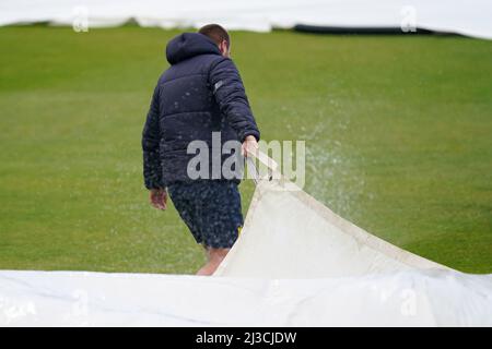 Ground staff prepare the covers during a rain shower on day one of the LV= County Championship Division One match at Edgbaston Stadium, Birmingham. Stock Photo