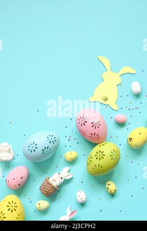 Easter composition. Easter eggs and easter bunny on pastel blue background. Minimal concept of Easter. Flat lay, top view, copy space Stock Photo