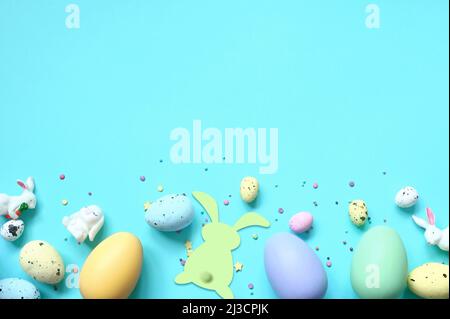 Easter composition. Easter eggs and easter bunny on pastel blue background. Minimal concept of Easter. Flat lay, top view, copy space Stock Photo