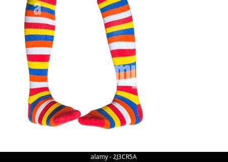 Female legs wearing striped socks over white