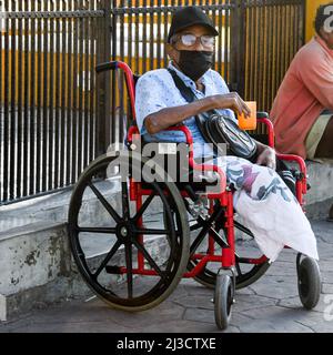 Elderly handicapped man begging in Valladolid, Mexico.The Covid-19 Pandemic increased the social inequalities and the amount of vulnerable people in Mexico and around the world. March 2022 Stock Photo