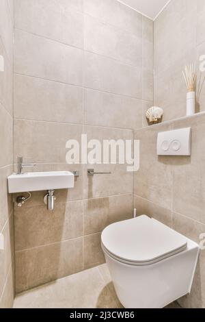 Toilet placed at wall in light small bathroom at home Stock Photo
