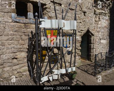 Inside The Gatehouse, Chepstow Castle, showing new iron gates decorated with medieval, lances, crest, and pennant. Stock Photo